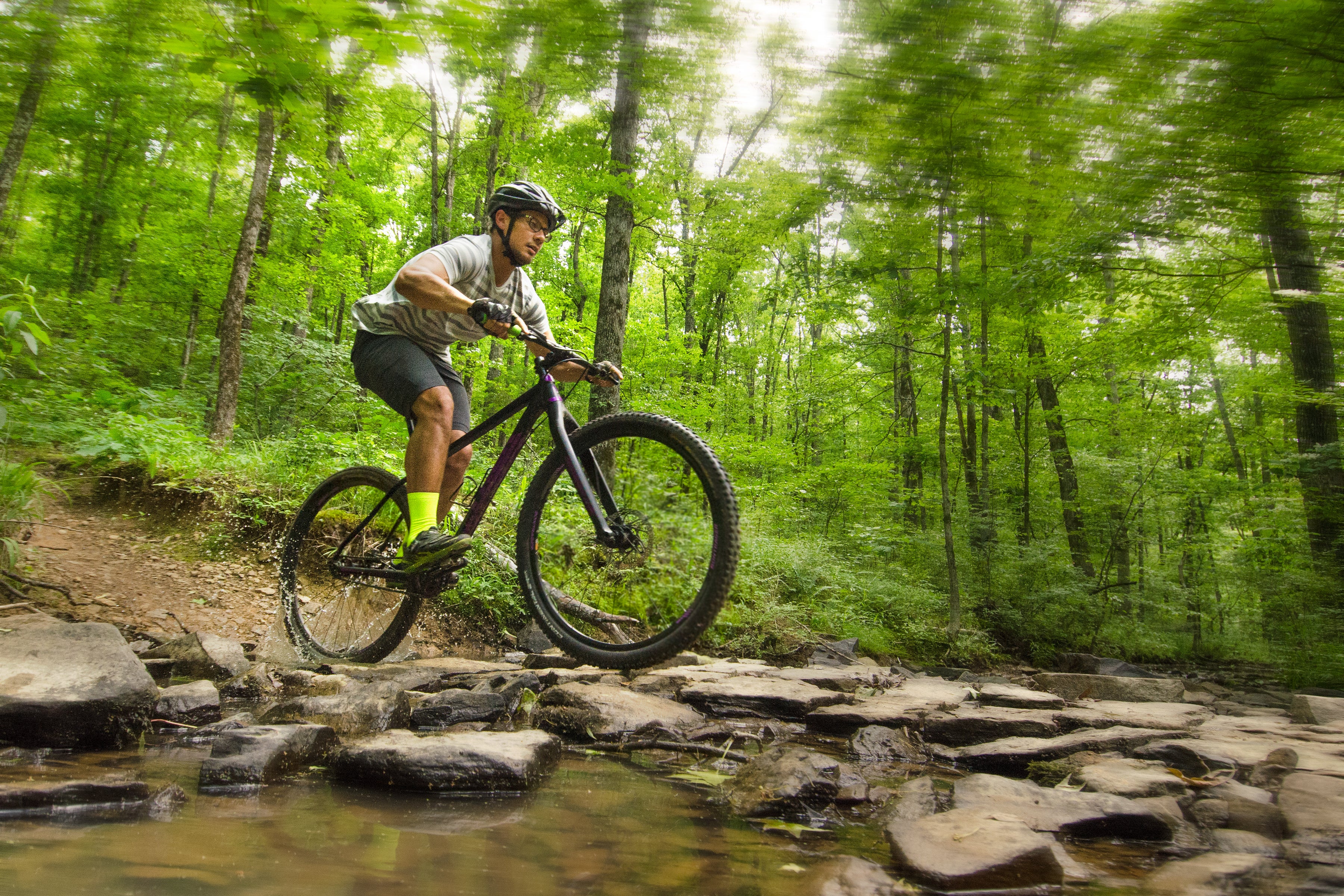 A man mountain biking on a trail at Woolly Hollow State Park